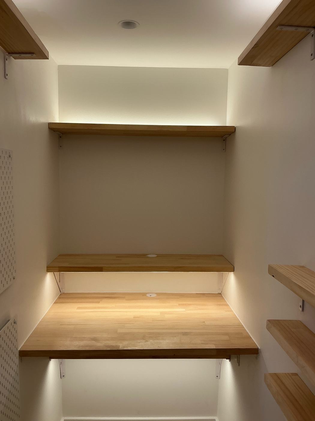 Curved pine shelves and a lit desk nook